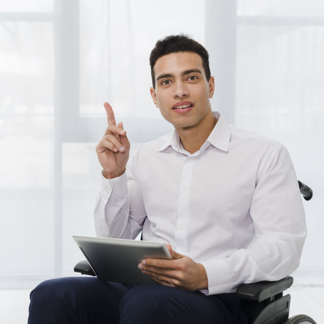 optimize-portrait-young-businessman-sitting-wheelchair-holding-digital-tablet-hand-pointing-his-finger-upward.jpg